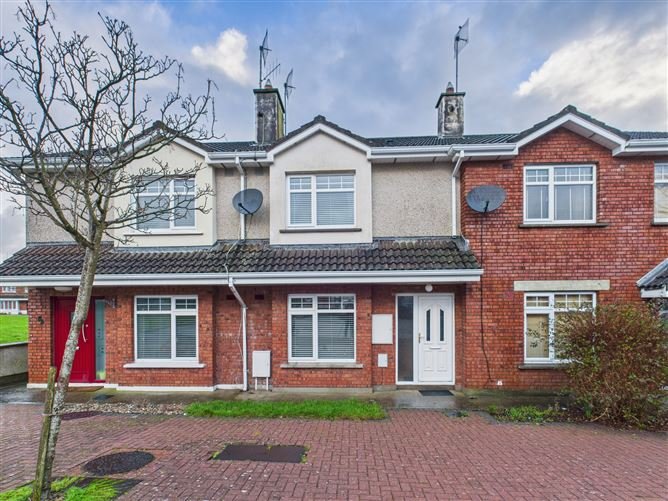 Row of terraced houses with brick facades and small front yards.