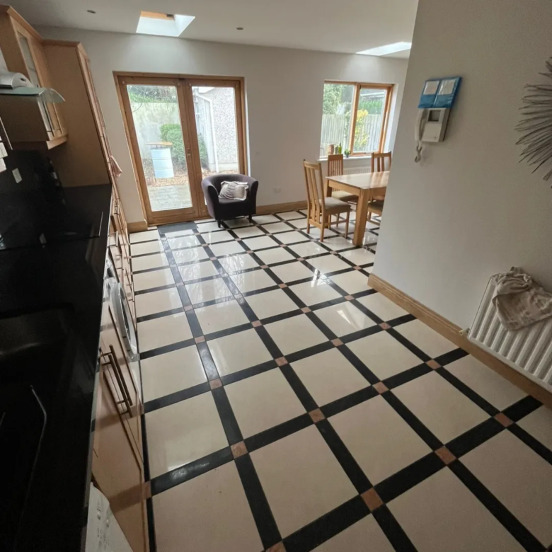 Checkerboard kitchen floor with dining area and natural light.