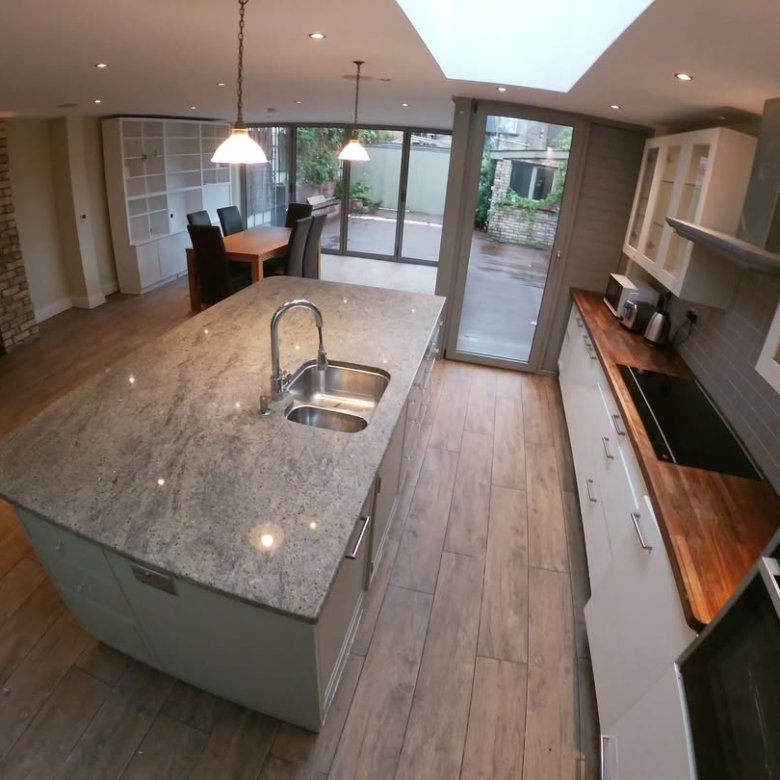 Modern kitchen with large island, stainless steel appliances, and open floor plan.