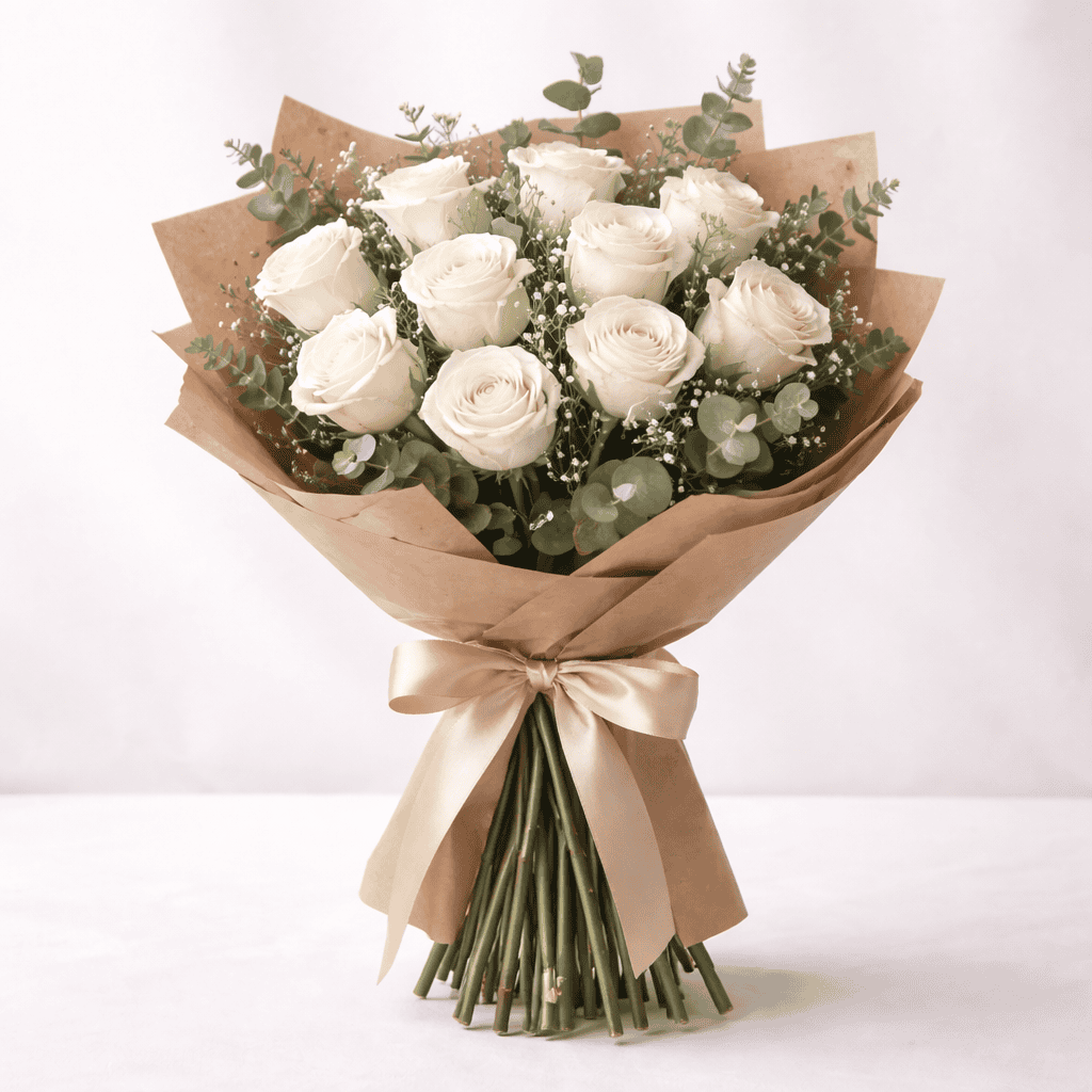 Elegant bouquet of white roses with greenery, perfect for special occasions.