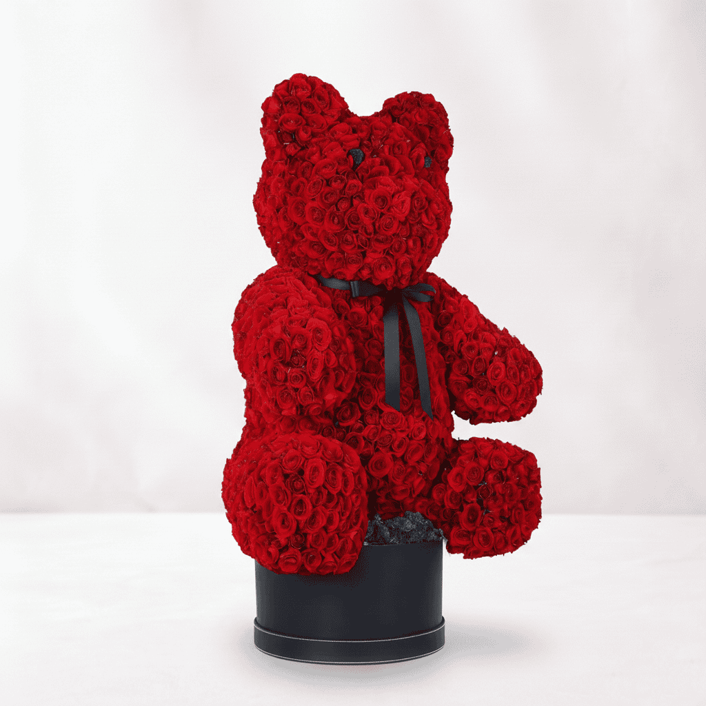 Red rose teddy bear arrangement for Valentine's Day, floral gift.