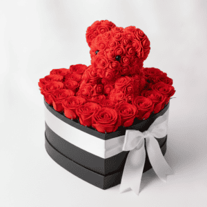 Beautiful red rose teddy bear in a heart-shaped gift box with roses, perfect for romantic occasions.