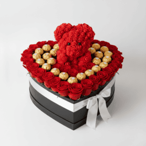 Heart-shaped box of red roses with teddy bear and Ferrero chocolates for special occasions.