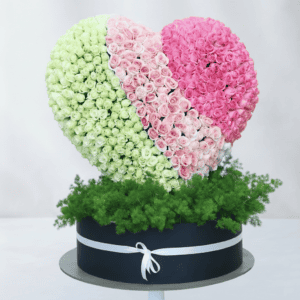 Shaped floral arrangement with pink and white roses, perfect for romantic occasions.