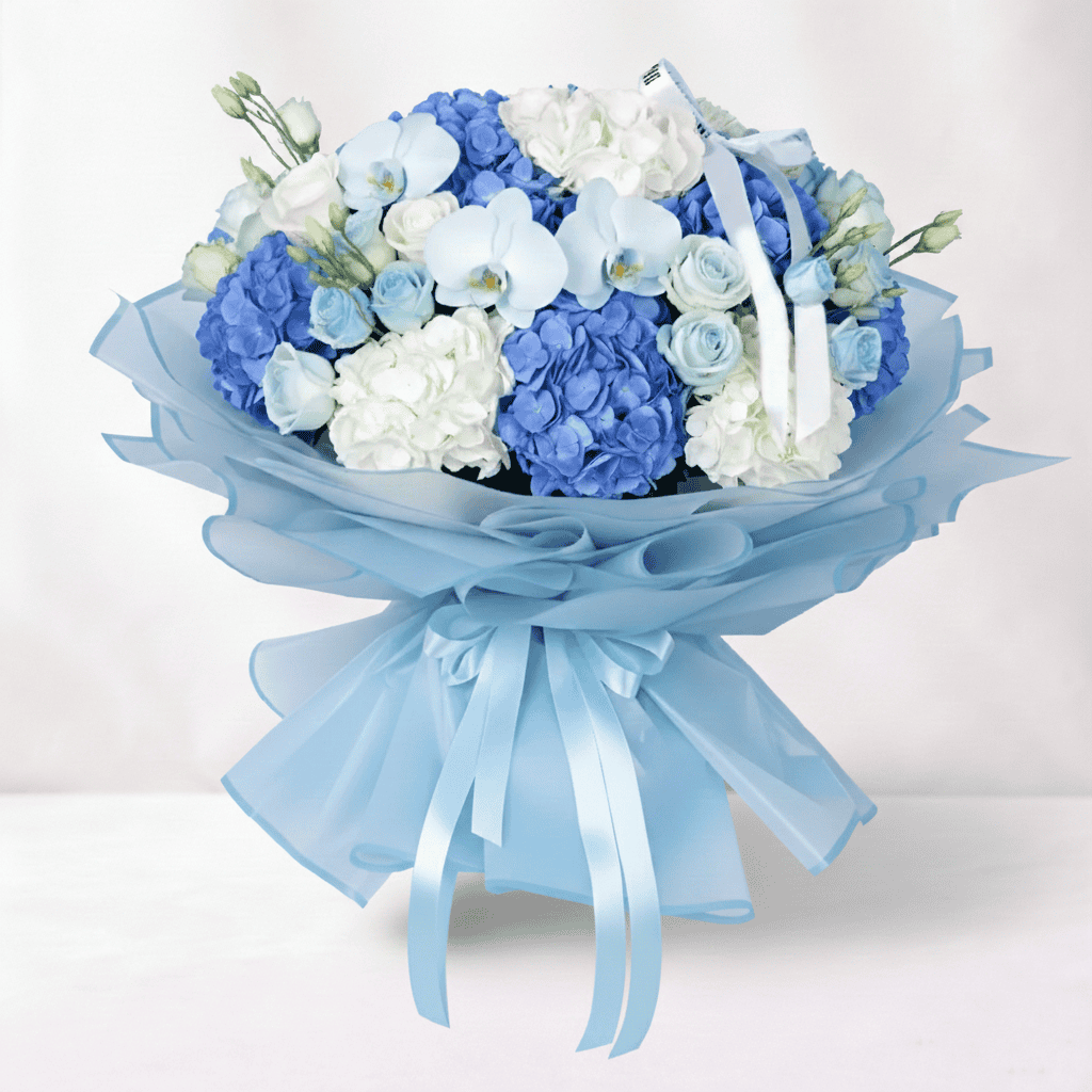 Elegant blue and white hydrangea, rose, and orchid floral arrangement for special occasions.