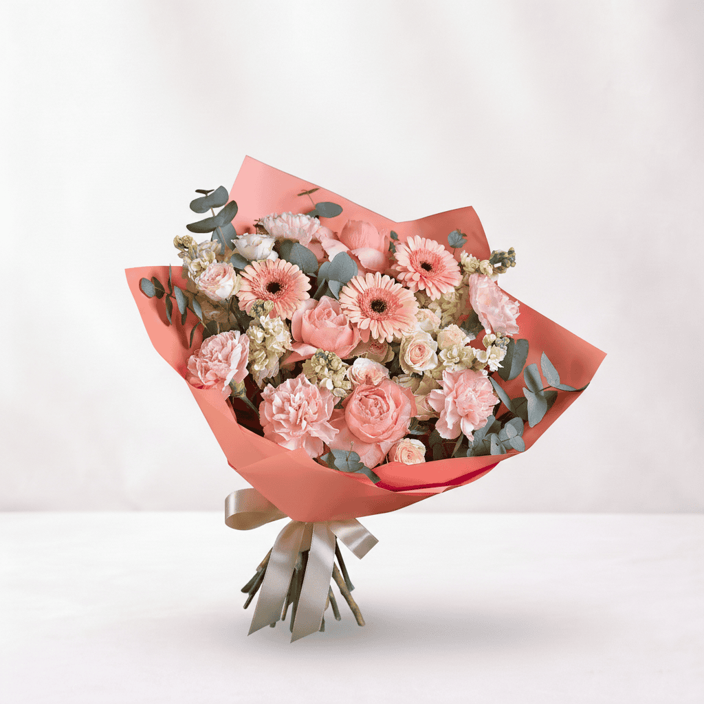 Pink floral bouquet with roses and gerbera daisies, wrapped in pink paper, symbolizing love and roma.