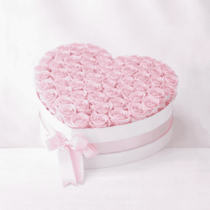 Heart-shaped box filled with pink roses, perfect for romantic gifts.