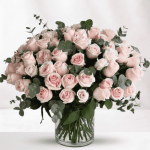 Elegant pink roses bouquet with eucalyptus in a glass vase.