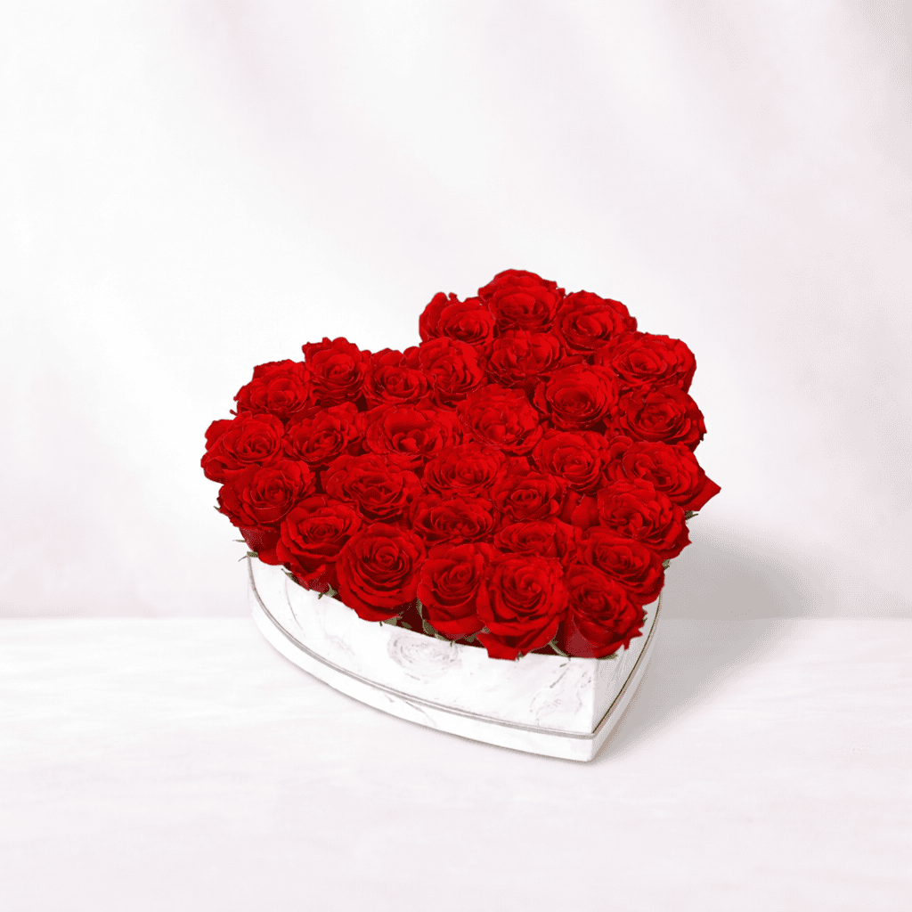 Beautiful red roses arranged in a heart-shaped box for romantic occasions.