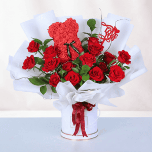 Beautiful red roses and a rose teddy in a love-themed gift box for special occasions. Perfect romant.