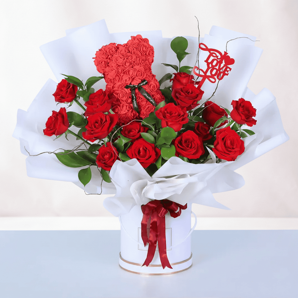 Beautiful red roses and a rose teddy in a love-themed gift box for special occasions. Perfect romant.