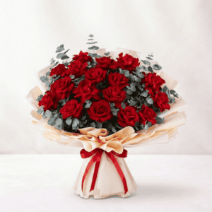 Elegant bouquet of vibrant red reflex roses with eucalyptus accents, perfect for gifting or decorati.