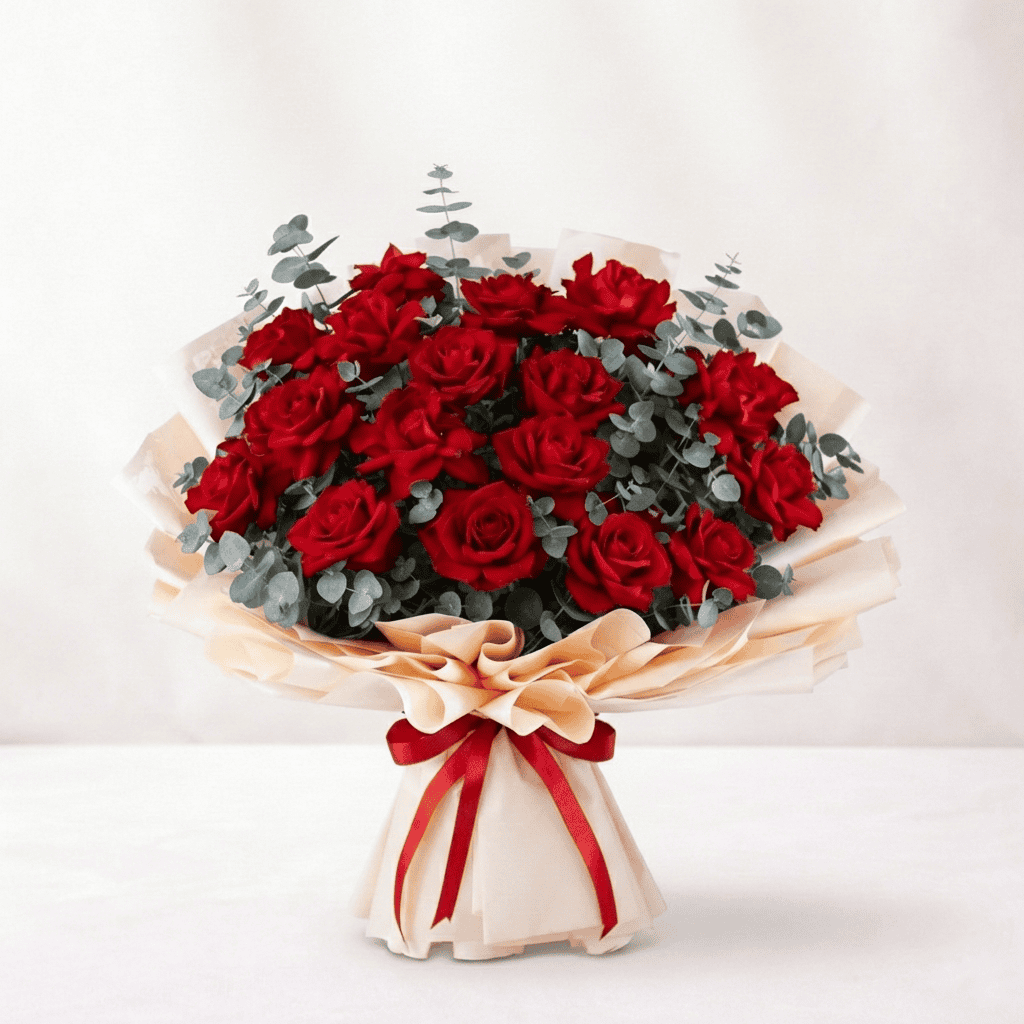 Elegant bouquet of vibrant red reflex roses with eucalyptus accents, perfect for gifting or decorati.