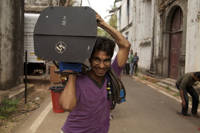Lighting Rental in India: Lightboy carrying a light on feature film set in India