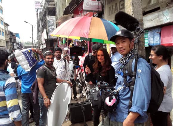 Goa Film Services fixer managing a crowd during a Netflix street shoot in Bangalore