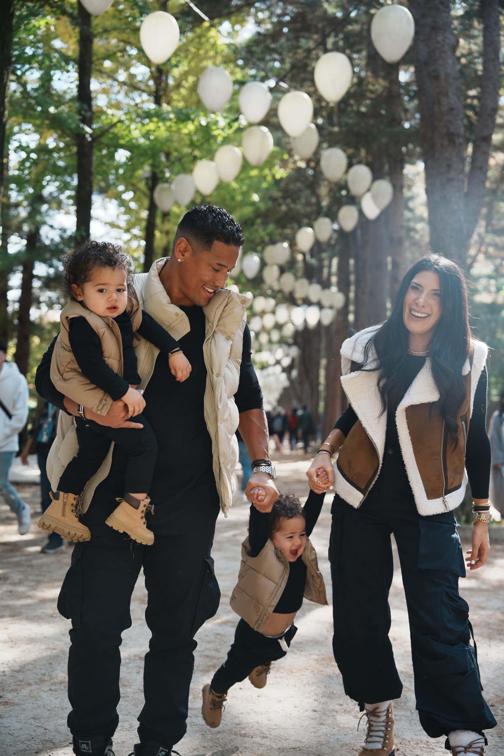 Family-friendly outdoor photography in Korea during golden hour, capturing joyful moments of parents and children, with beautiful natural lighting and scenic background.