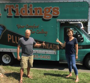 %Focuskw% | Good Tidings Plumbing, Heating &Amp; Cooling Two people stand on grass in front of a green plumbing and heating service van, both giving thumbs up and smiling.