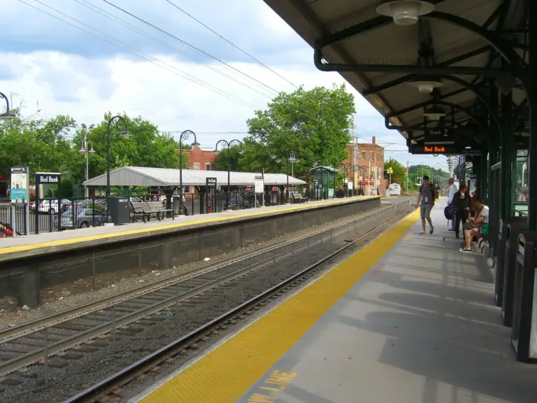 Commuters wait on the platform at the Red Bank train station.