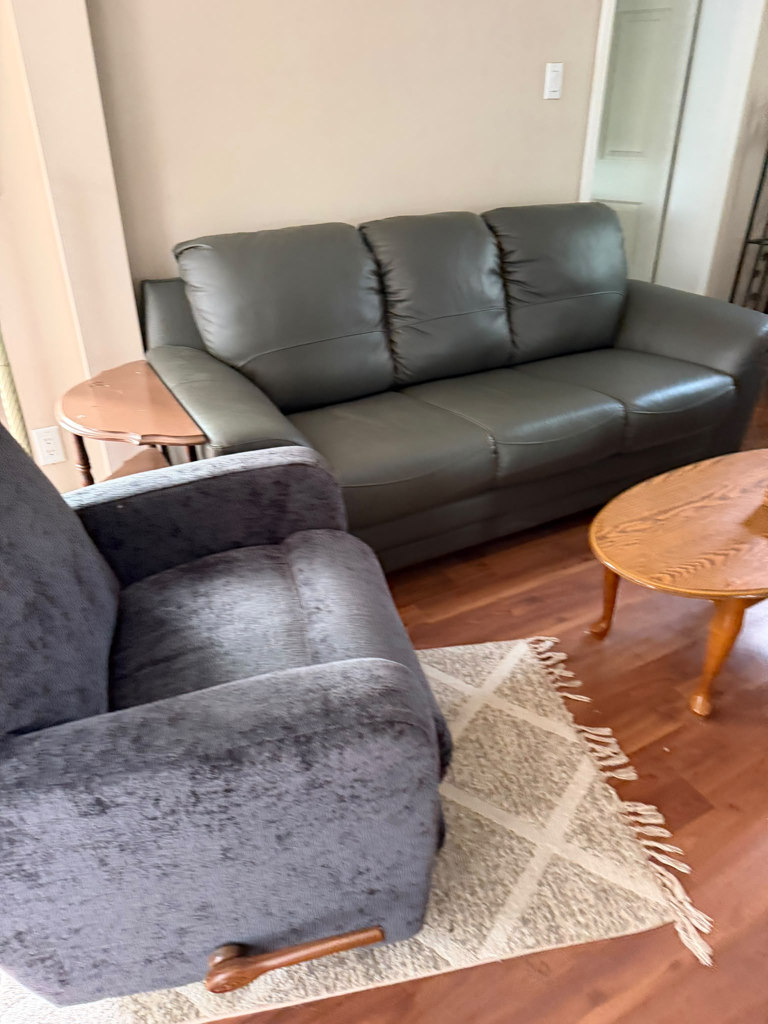 Movers packing household items into boxes in a modern living room.