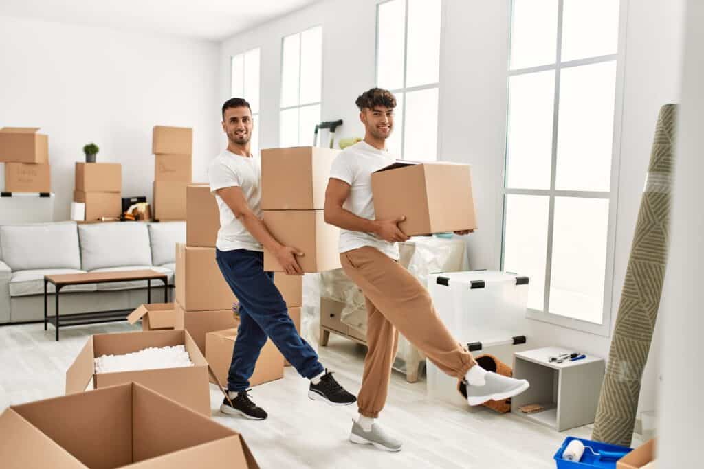 Movers packing boxes in a bright, modern apartment in Abbey.