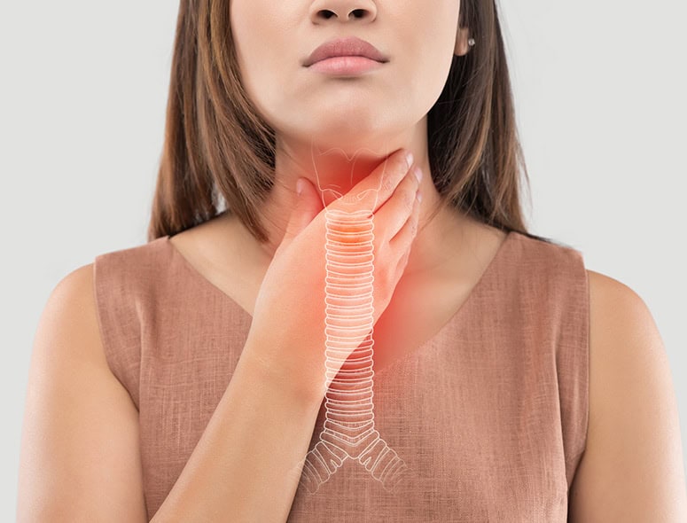 Woman with hand on throat showing esophageal health awareness.