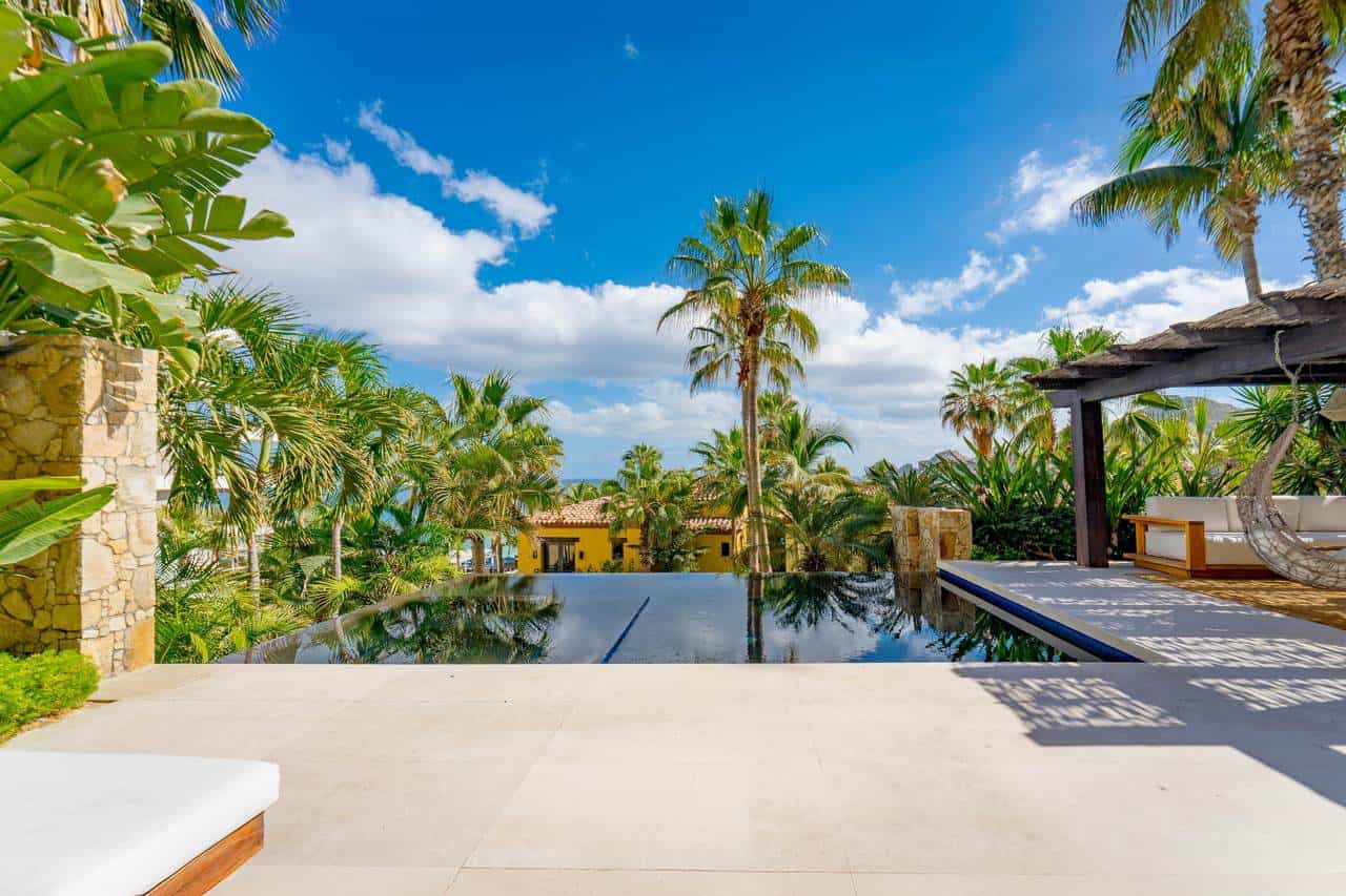 Stunning Luxury Villa At Hacienda Featuring An Infinity Pool, Lush Tropical Gardens, And Modern Outdoor Lounging Areas, Perfect For Relaxing And Enjoying Ocean Views.