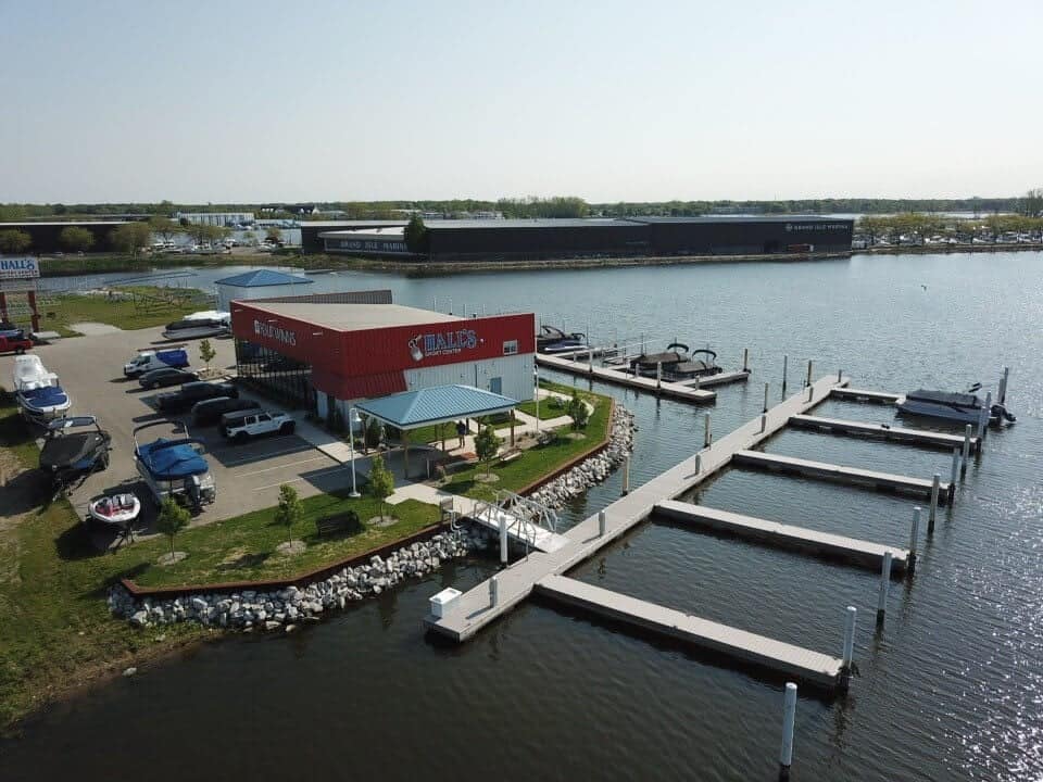 Harbor view of Hall's Sport Center with boats and pier docks by the water.
