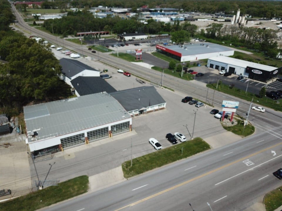 Aerial view of Hall's Sport Center with parking lot and surrounding commercial buildings.