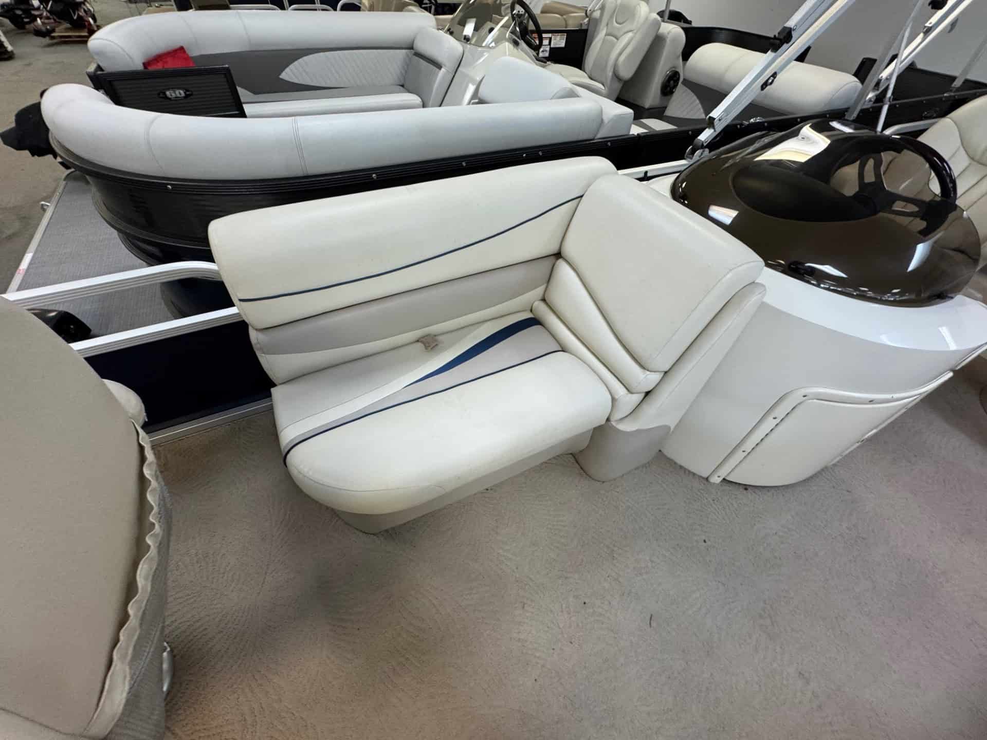 Pontoon boat with white seating and black accents at Hall's Sport Center.