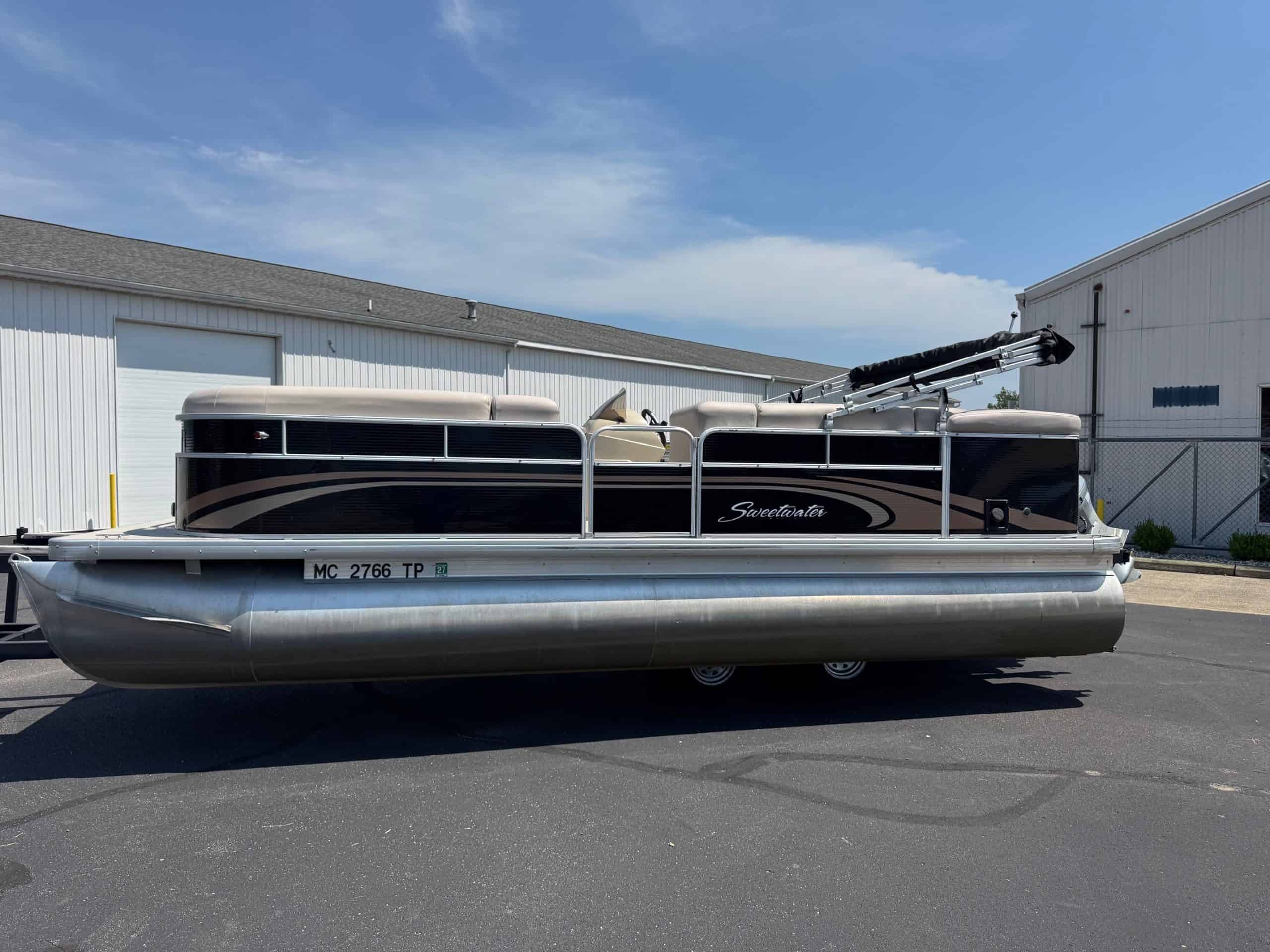 Pontoon boat with black and silver exterior, ideal for water recreation.