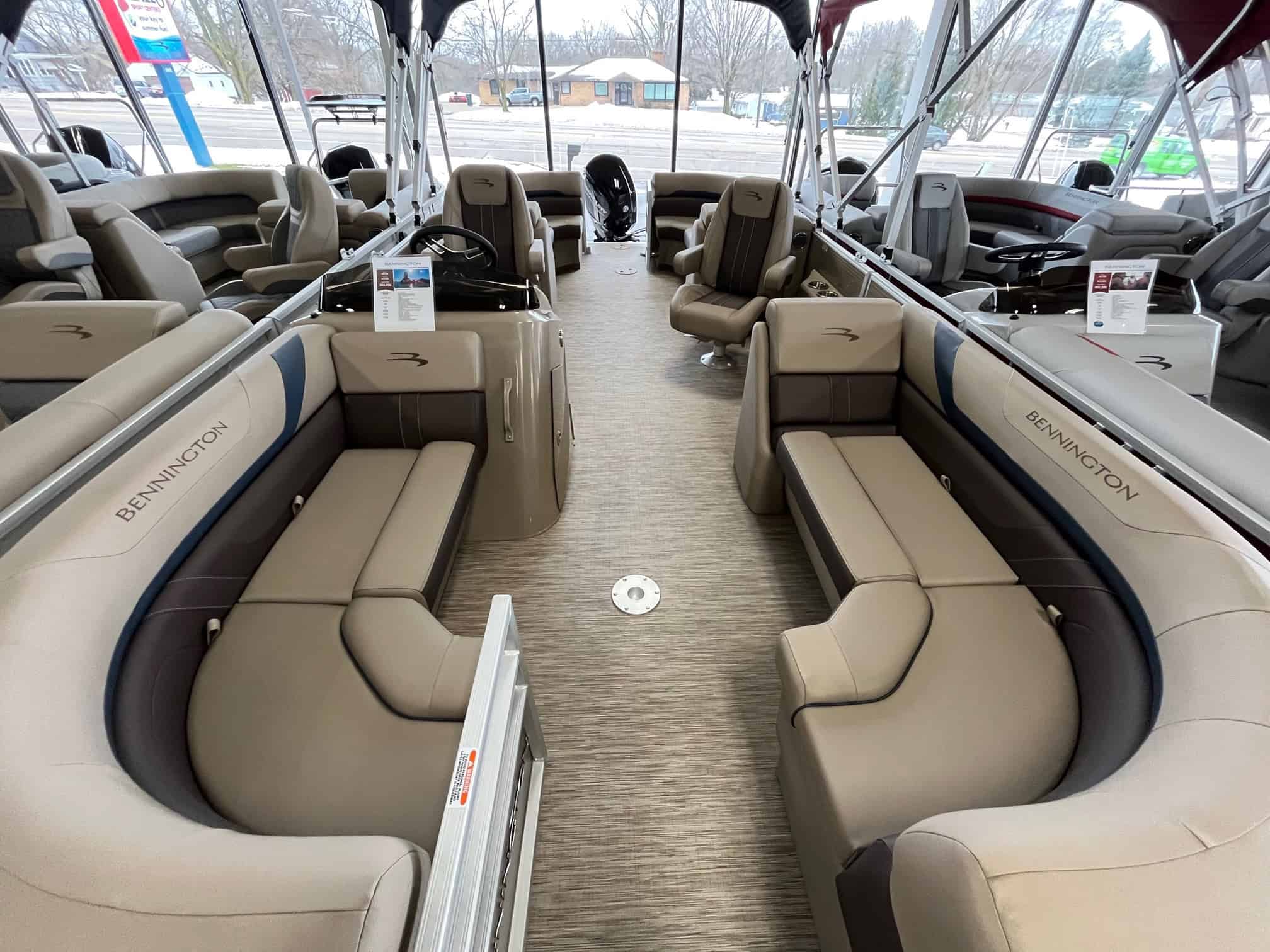 High-quality Bennington pontoon boats displayed at Hall's Sport Center with spacious seating and modern features.