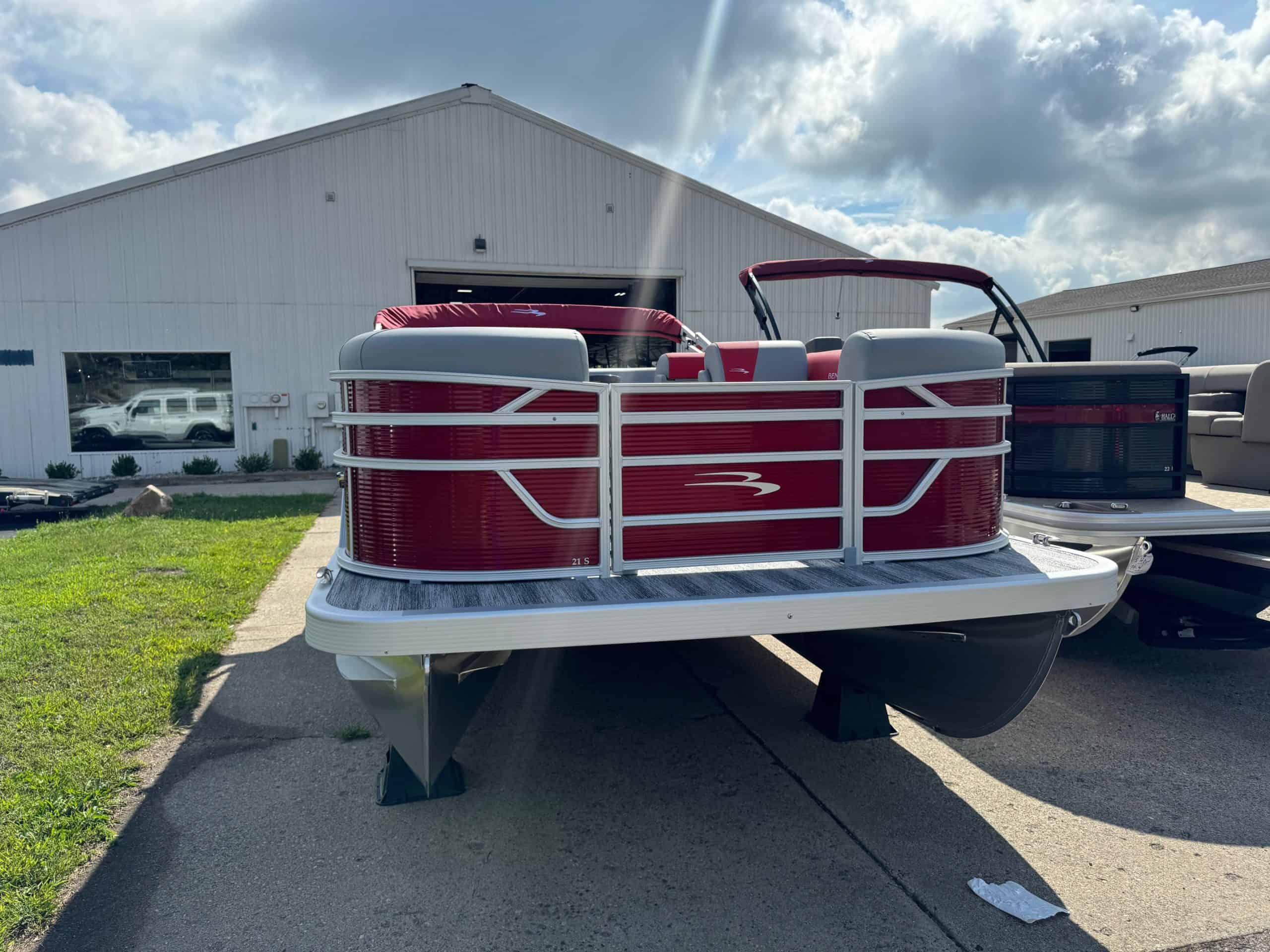 Bennington 21 SL pontoon boat displayed at Hall's Sport Center, perfect for family outings and water.