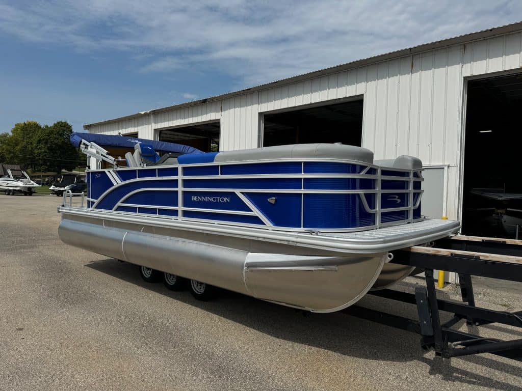Blue and silver Bennington 21 SL pontoon boat displayed outside Hall's Sport Center.