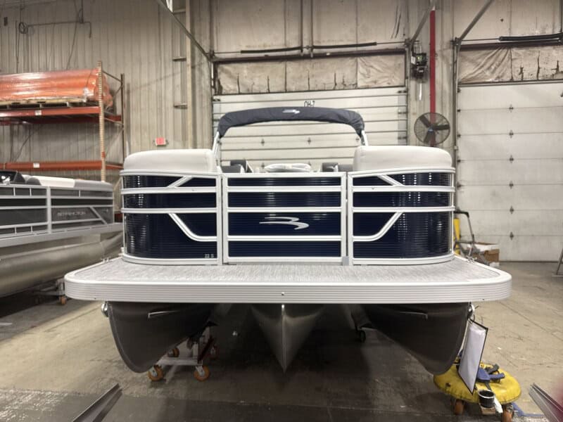 Bennington 22 SSR pontoon boat in Hall's Sport Center showroom. Perfect for family fun and water adv.