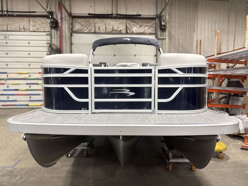 Front view of a 2026 Bennington 22 SSR pontoon boat in a warehouse.