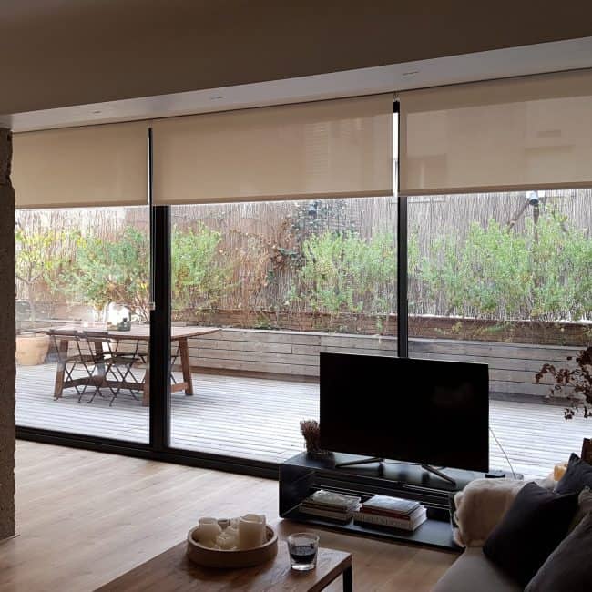 Amplia reforma de interiores con puertas correderas y orientación a terraza exterior en vivienda.