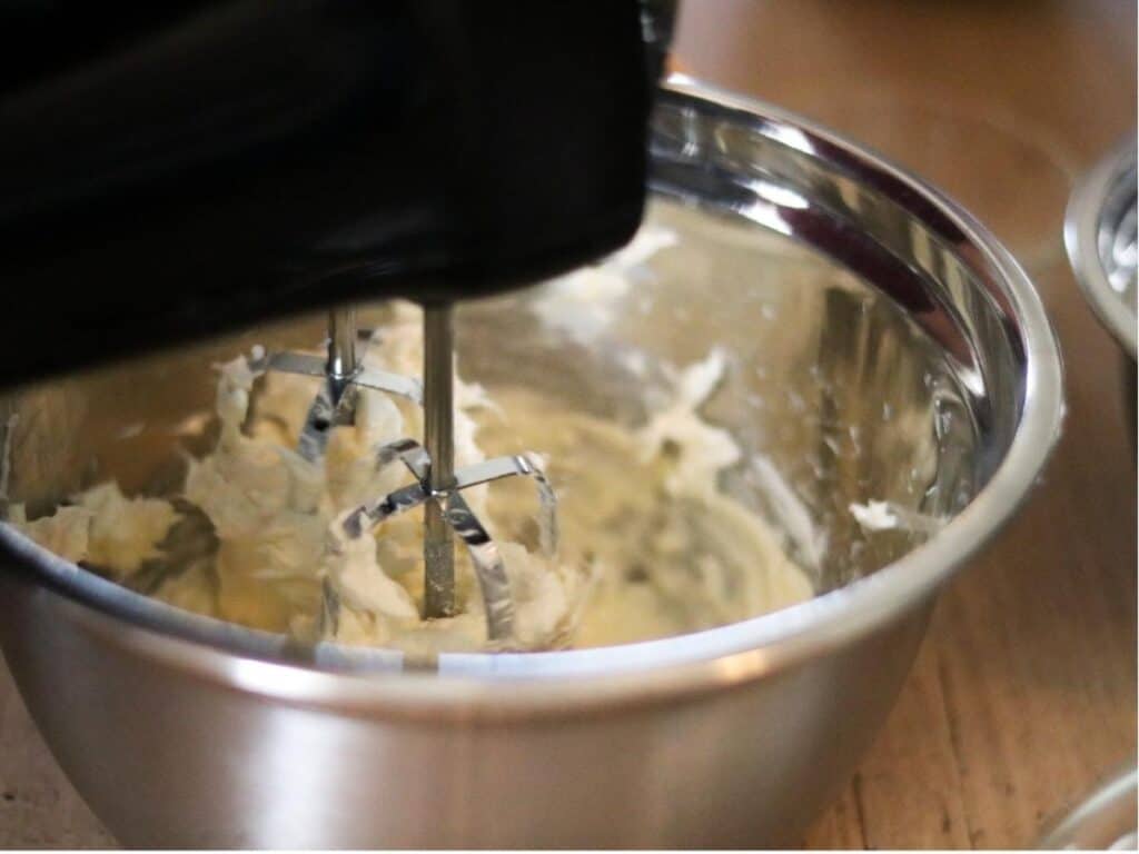 electric mixer beating cream cheese and butter