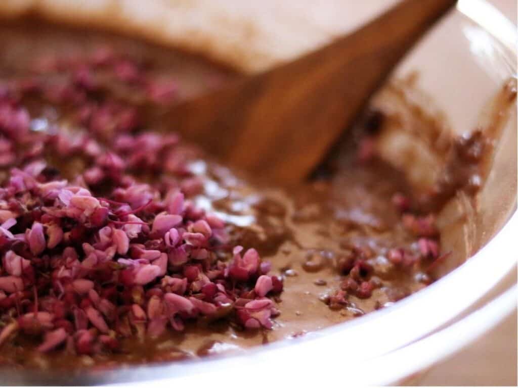 close up of redbuds being stirred into cake batter