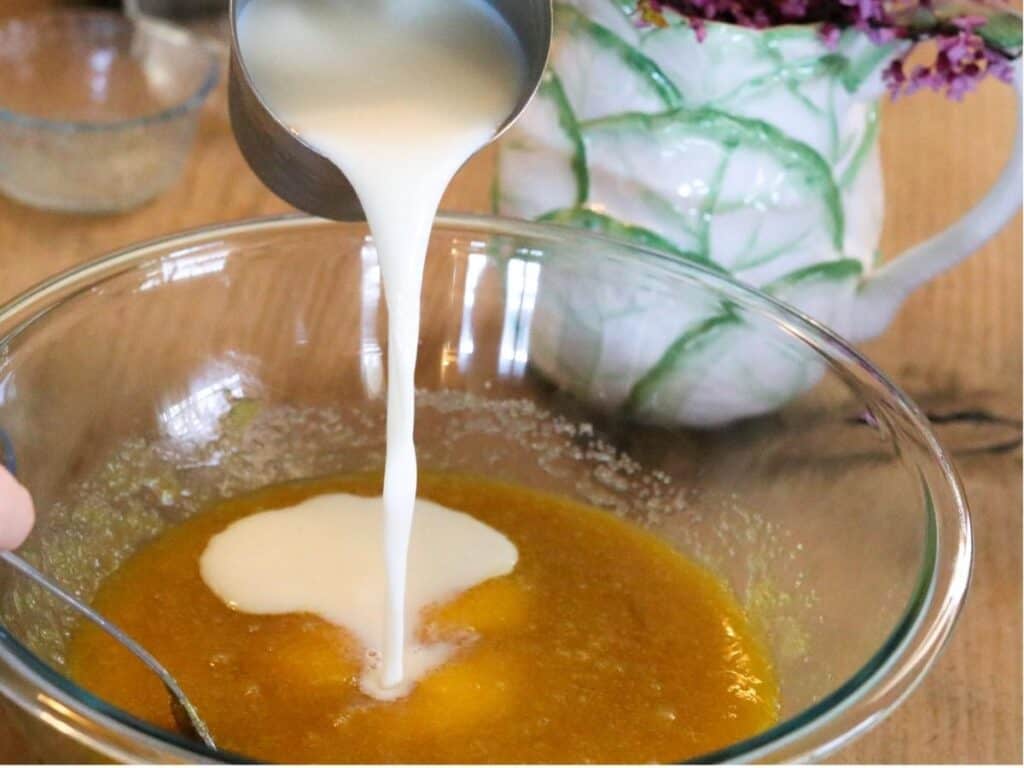 pouring milk into cake batter