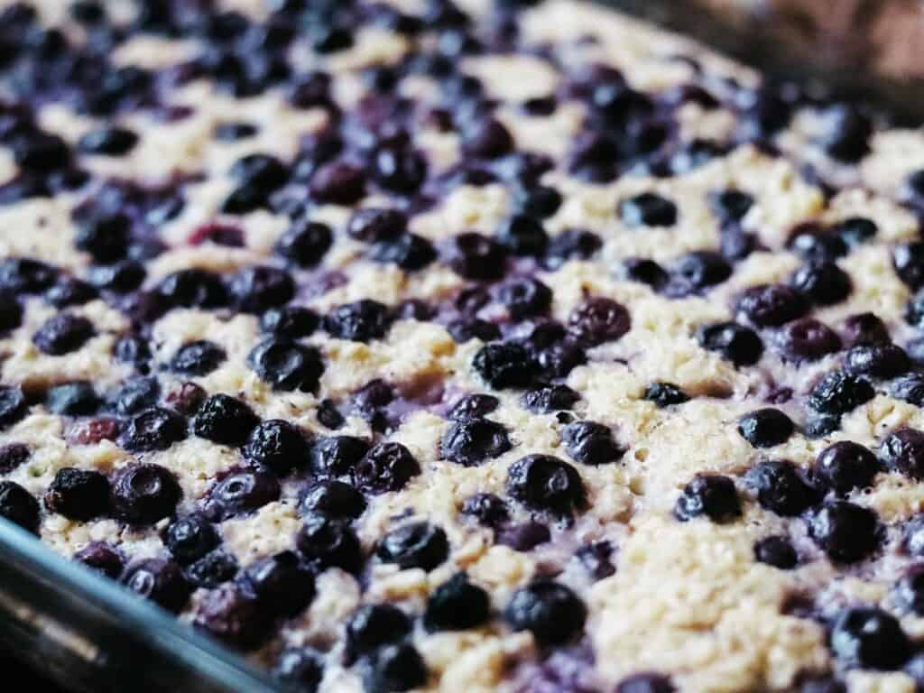 close up of blueberry soaked baked oatmeal in a pan