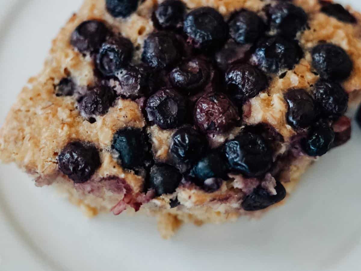 slice of blueberry baked oatmeal on a white plate
