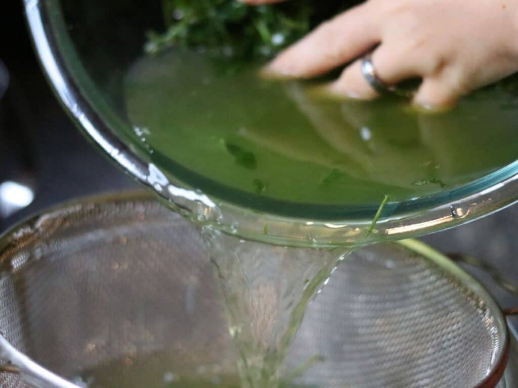 straining tea through a sieve
