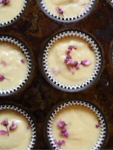 lemon muffins with redbuds batter in a muffin tin