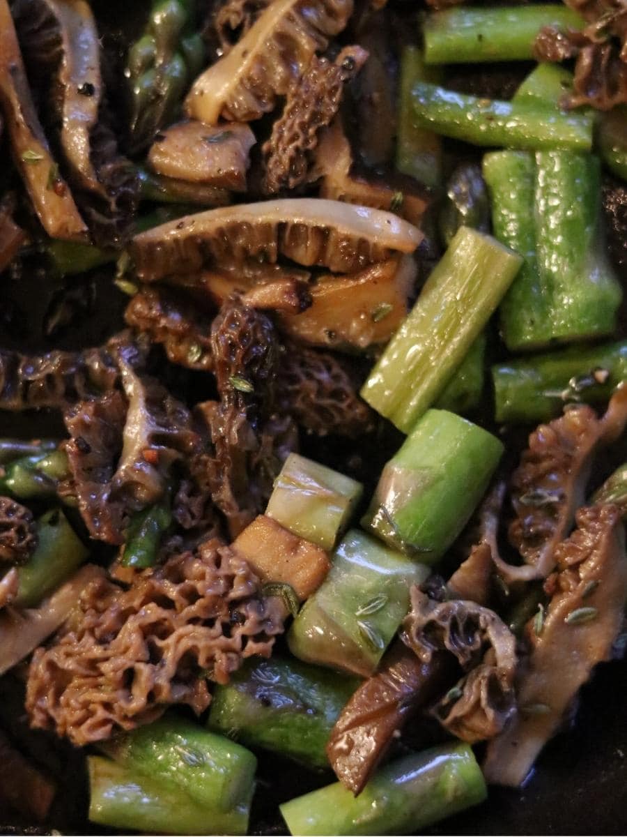 sautéed morels and asparagus in a cast iron pan