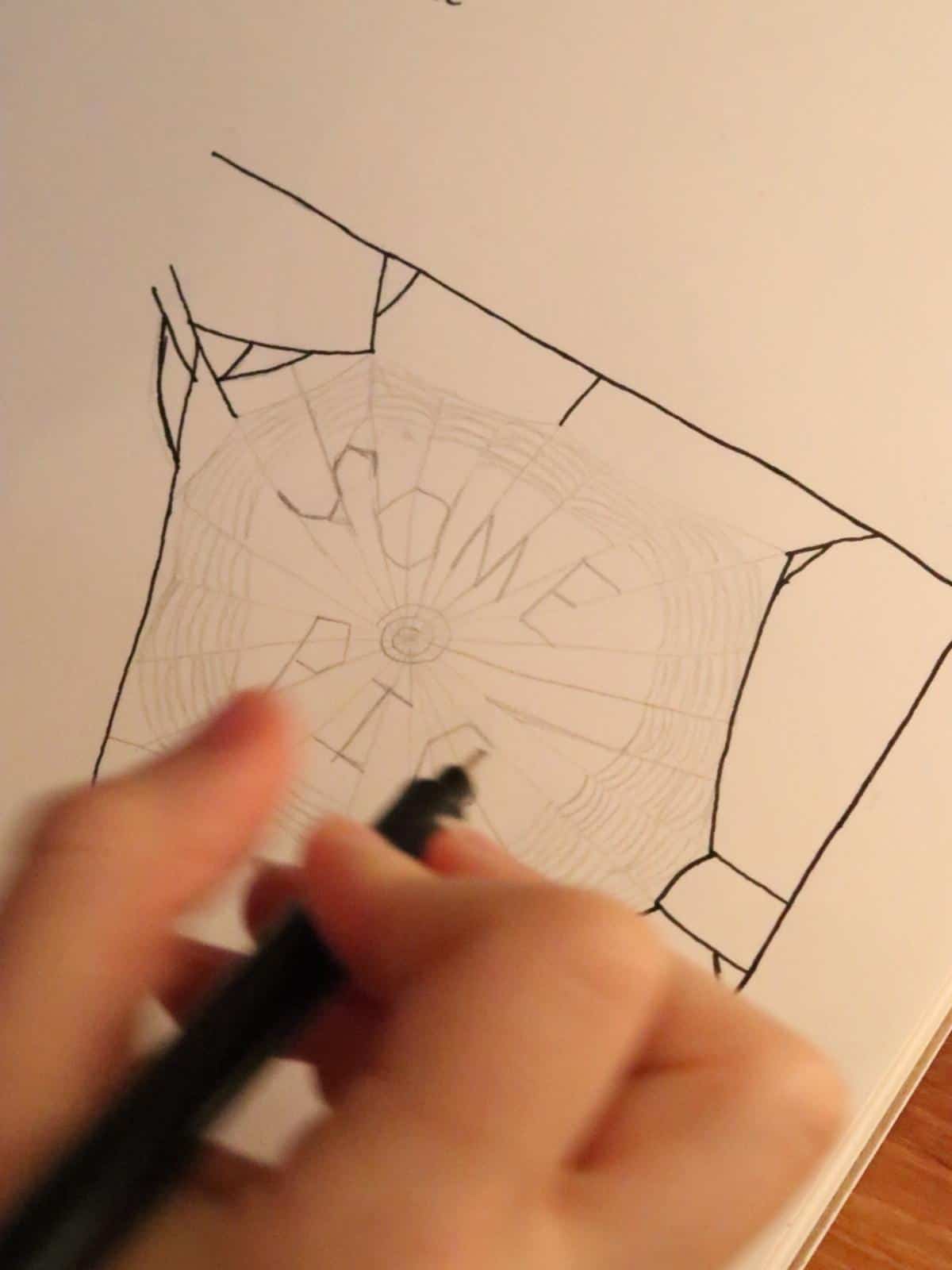 girl inking over a pencil underdrawing