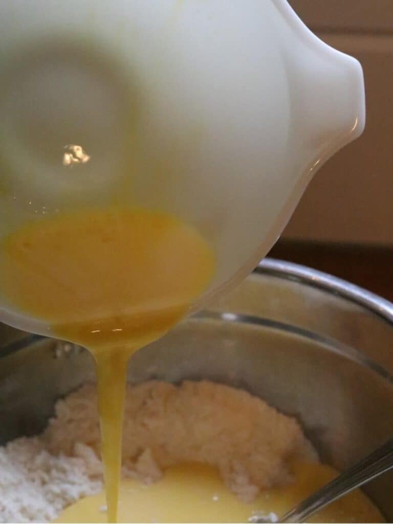 pouring eggs into batter