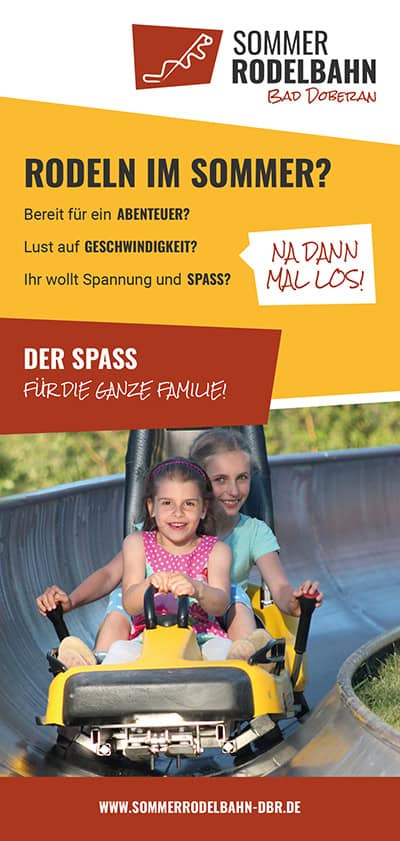 Eine Frau und ein junges Mädchen lächeln, als sie gemeinsam auf einer gelben Sommerrodelbahn auf einer Bahn fahren. Das Bild wirbt für die Sommerrodelbahn Bad Doberan in Deutschland und hebt den Spaß für die ganze Familie hervor.