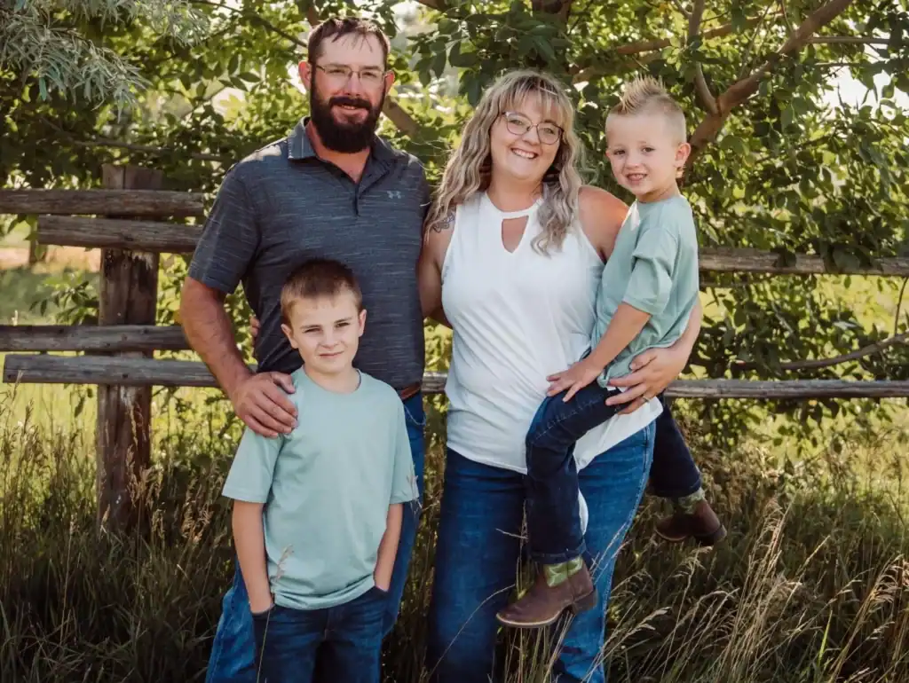 Family enjoying outdoor activities with trained service dogs, showcasing the positive impact of High Plains K-9 Connections on community and family well-being.