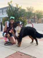 K-9 Connections dog training, therapy, and service dogs, woman with Bernese Mountain Dog, community outreach, dog handler with awards, outdoor sidewalk scene, pet therapy program, high plains K-9 connections, friendly dog and handler, therapeutic service dog training event, professional canine training and socialization.