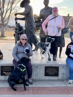 Service dogs and owners at High Plains K-9 Connections outdoor event, showcasing training and community support for therapy dogs, service dogs, and K-9 training programs.